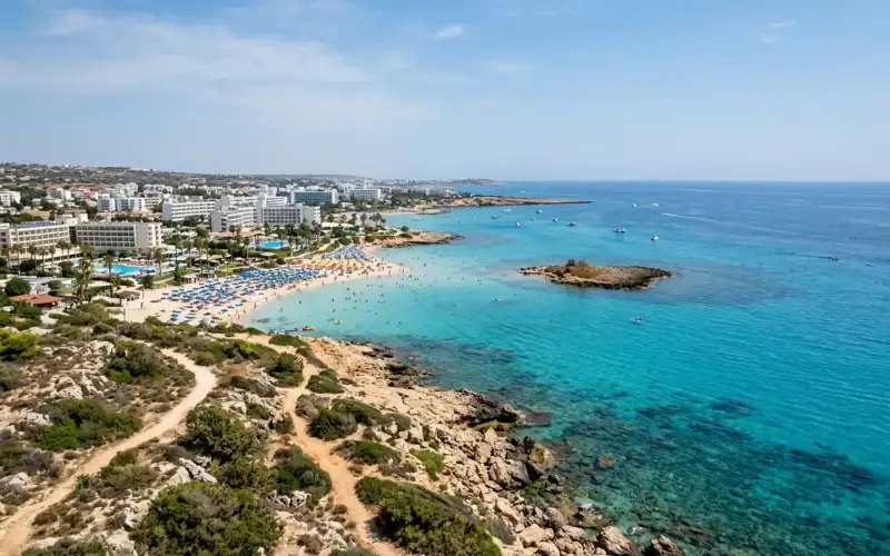 Golden sands and turquoise waters invite families to relax at beautiful Fig Tree Bay in Protaras, Cyprus
